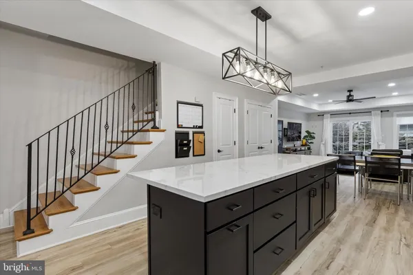 a kitchen with counter top space and wooden floor