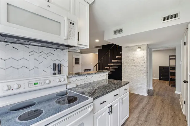 a kitchen with appliances cabinets and a counter top space