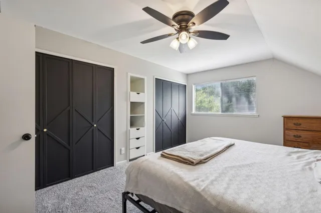 a bedroom with a bed closet and a window