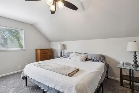 a bedroom with a bed and dresser