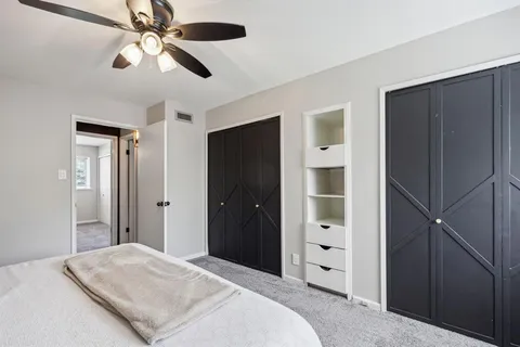 a bedroom with a large bed and a chandelier