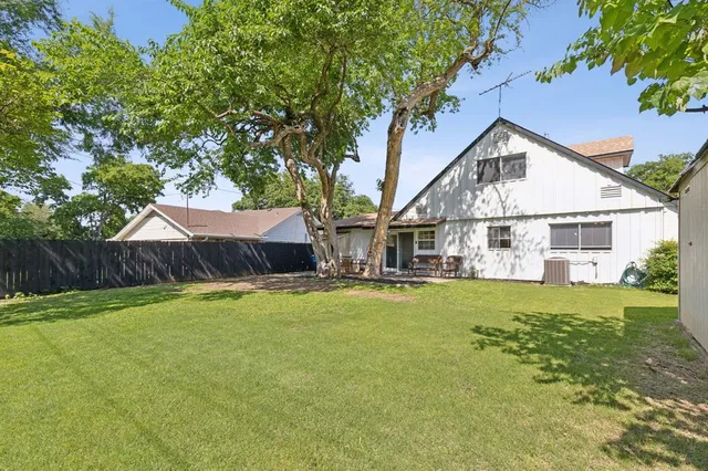 a view of house with outdoor space and swimming pool