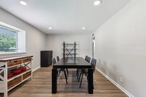 a view of a workspace with furniture and wooden floor