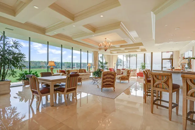 a living room with lots of furniture and a large window