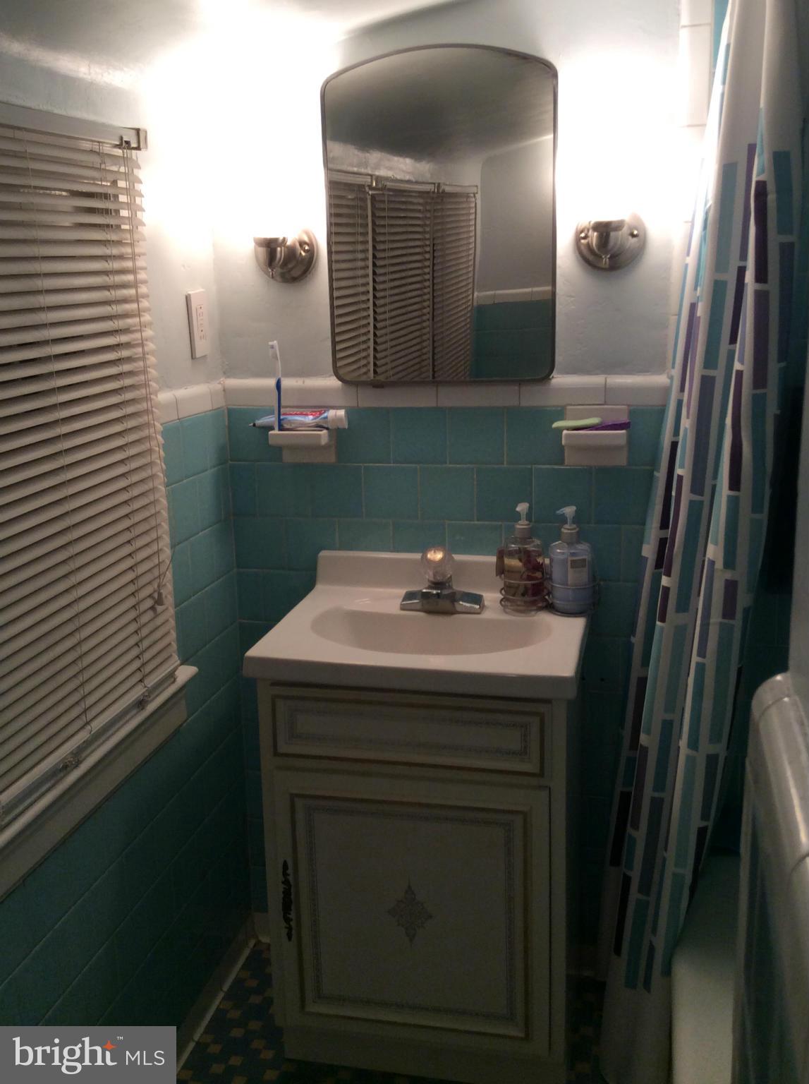 2700 Allendale Road Baltimore, MD 21216 - Photo 13 of 30 a bathroom with a sink and mirror