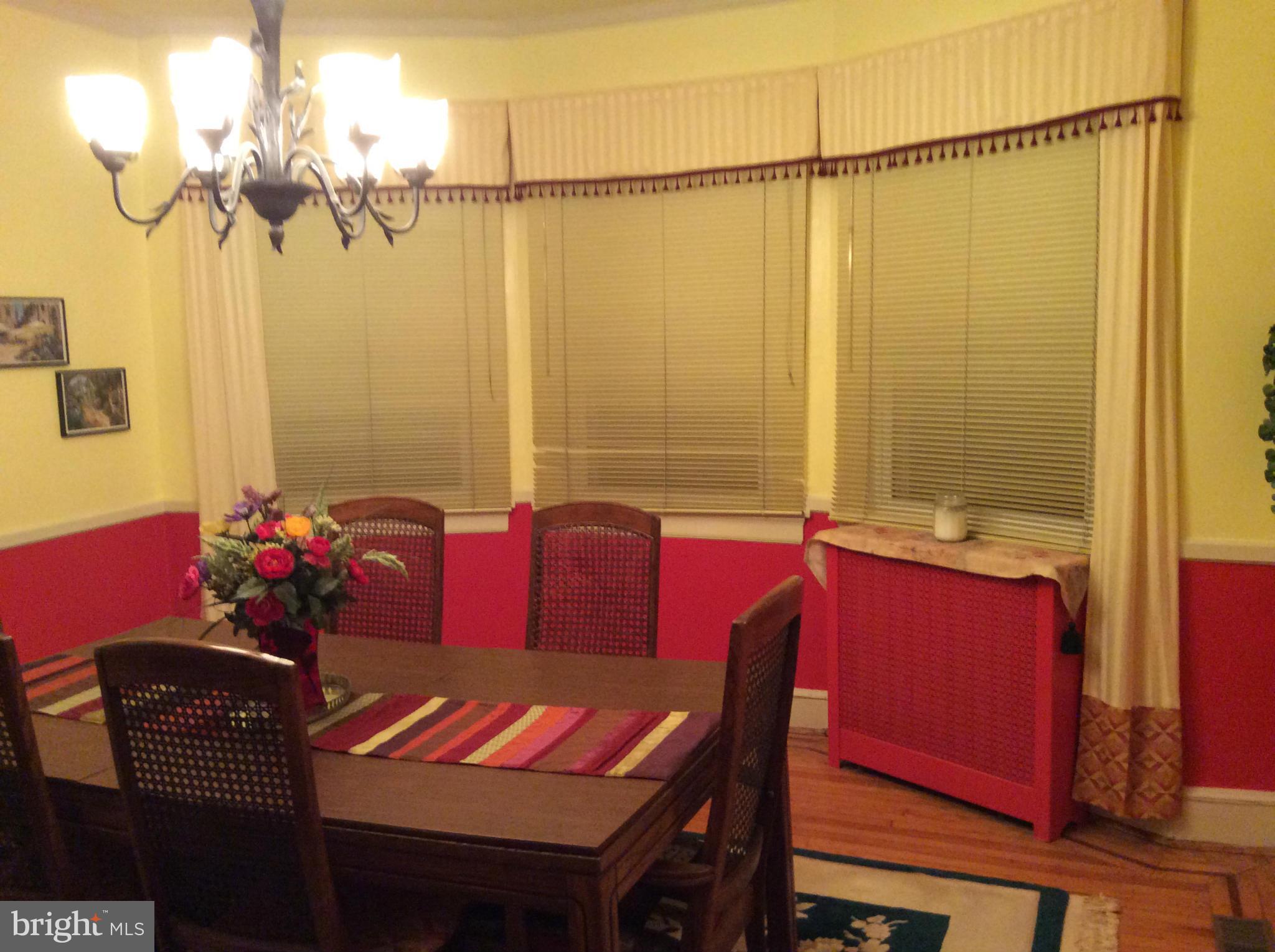 2700 Allendale Road Baltimore, MD 21216 - Photo 16 of 30 a view of a dining room with furniture and a chandelier