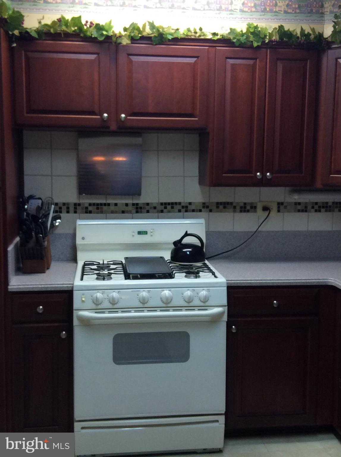 2700 Allendale Road Baltimore, MD 21216 - Photo 19 of 30 a kitchen with stainless steel appliances granite countertop a stove a sink and a microwave