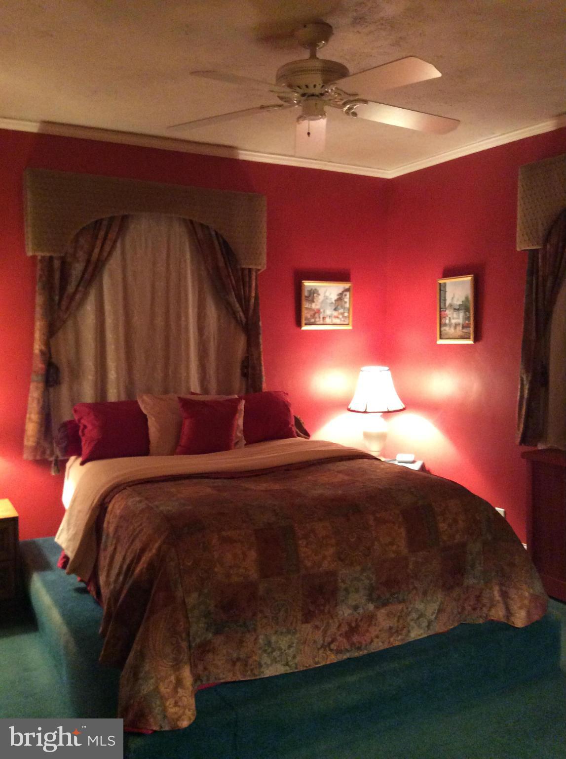 2700 Allendale Road Baltimore, MD 21216 - Photo 10 of 30 a bed sitting in a bedroom next to a lamp
