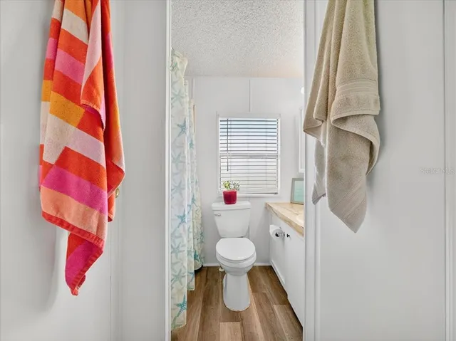 a bathroom with a toilet and a shower curtain