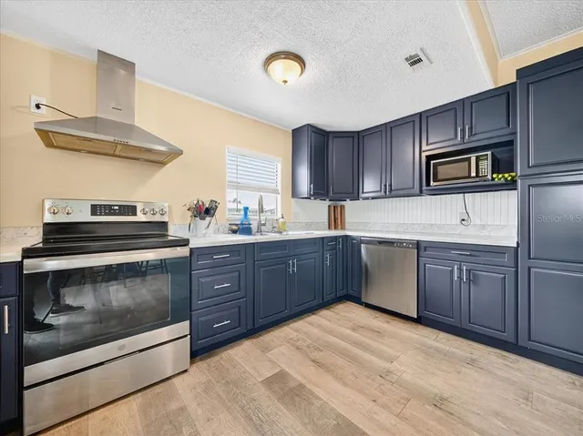 a kitchen with a sink stove and microwave