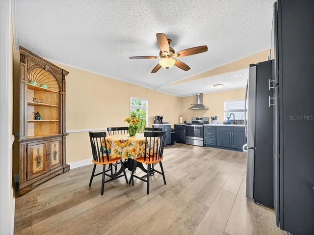 a view of a dining room with furniture and a window
