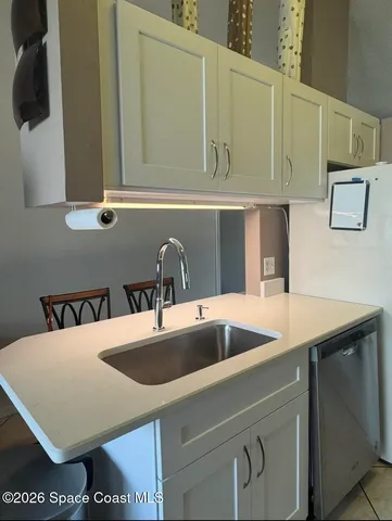 a kitchen with a sink and a refrigerator