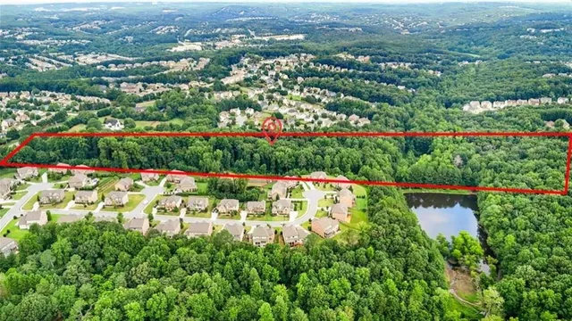 a backyard of a house with lots of green space and a fountain