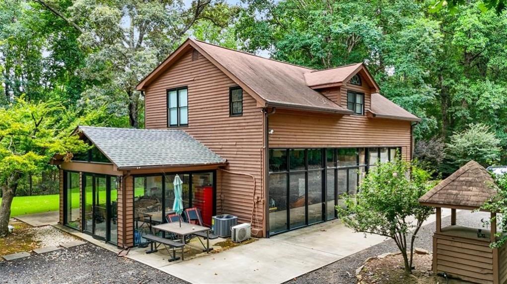 451 Nichols Drive Suwanee, GA 30024 - Photo 3 of 22 a view of house with outdoor seating area