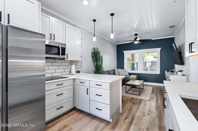 a view of a house with pool and chairs