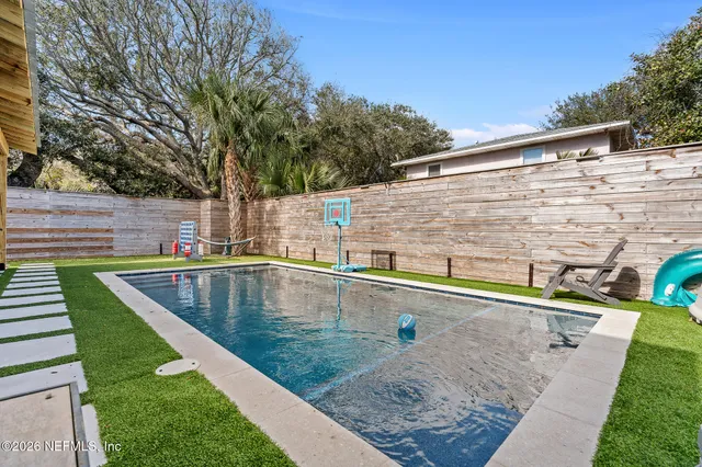 a kitchen with granite countertop white cabinets stainless steel appliances and sink