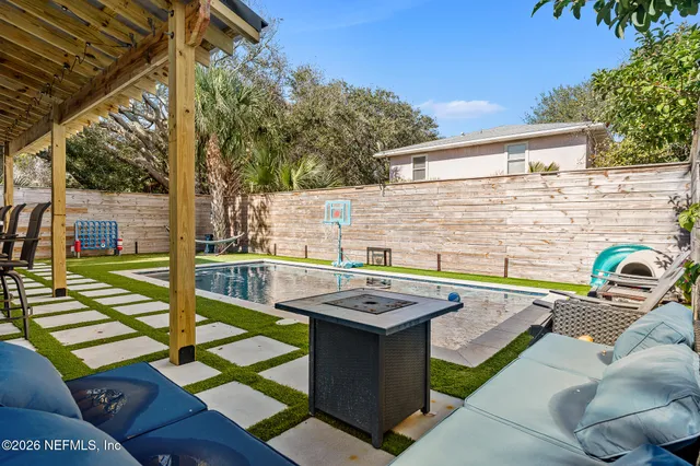 a view of a patio with table and chairs potted plants with wooden floor and fence