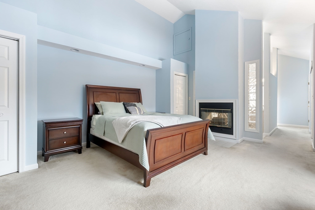 2 Arrowhead Circle, Unit 2 Ashland, MA 01721 - Photo 15 of 22 a bed room with a bed and a fireplace