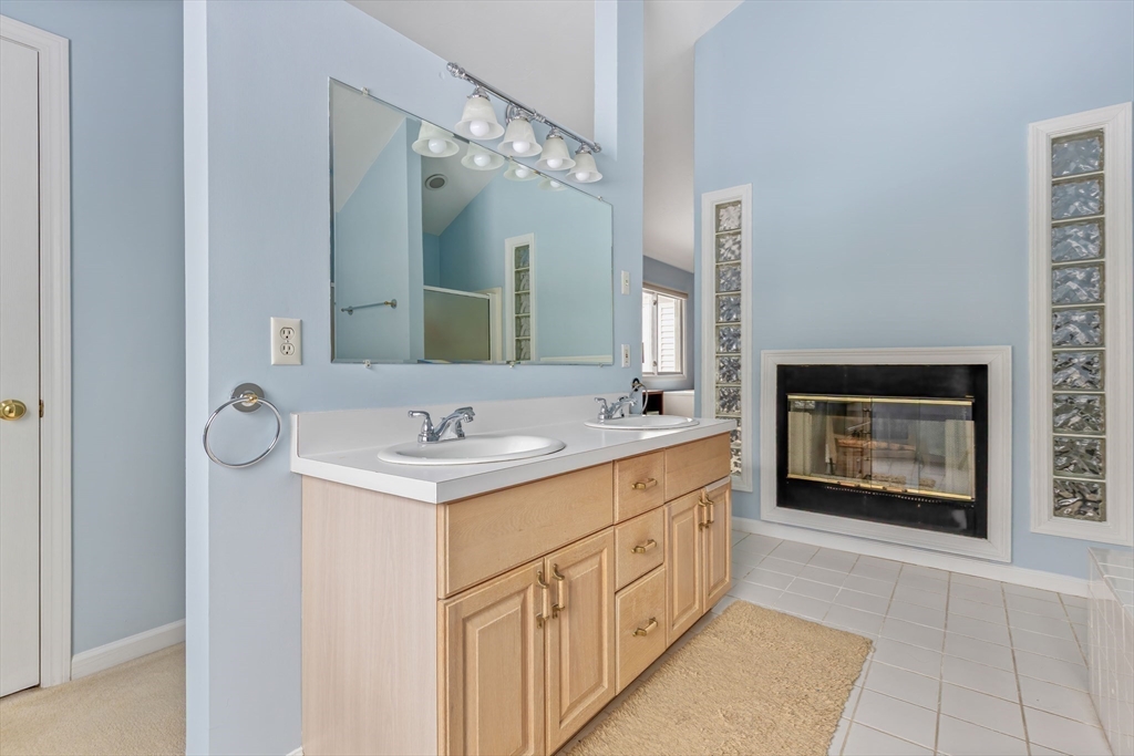 2 Arrowhead Circle, Unit 2 Ashland, MA 01721 - Photo 19 of 22 a bathroom with a sink a vanity and a mirror