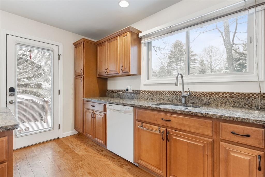 2 Arrowhead Circle, Unit 2 Ashland, MA 01721 - Photo 6 of 22 a kitchen with granite countertop a window sink and cabinets
