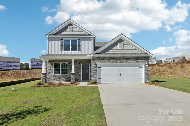 a front view of a house with a yard table and chairs