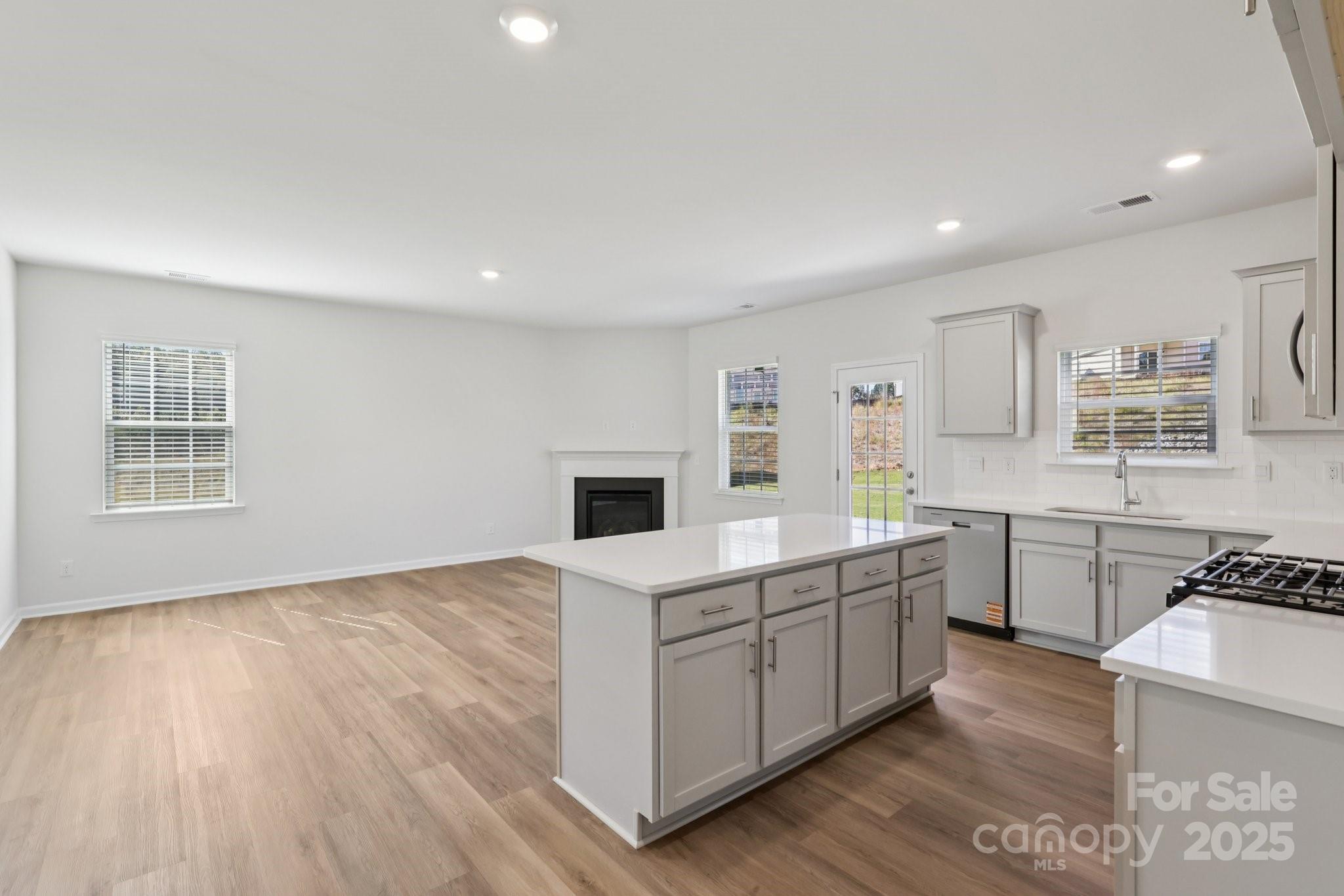 3919 Caroline Court Northwest Conover, NC 28613 - Photo 12 of 35 a kitchen with stainless steel appliances a stove top oven a sink dishwasher and a refrigerator
