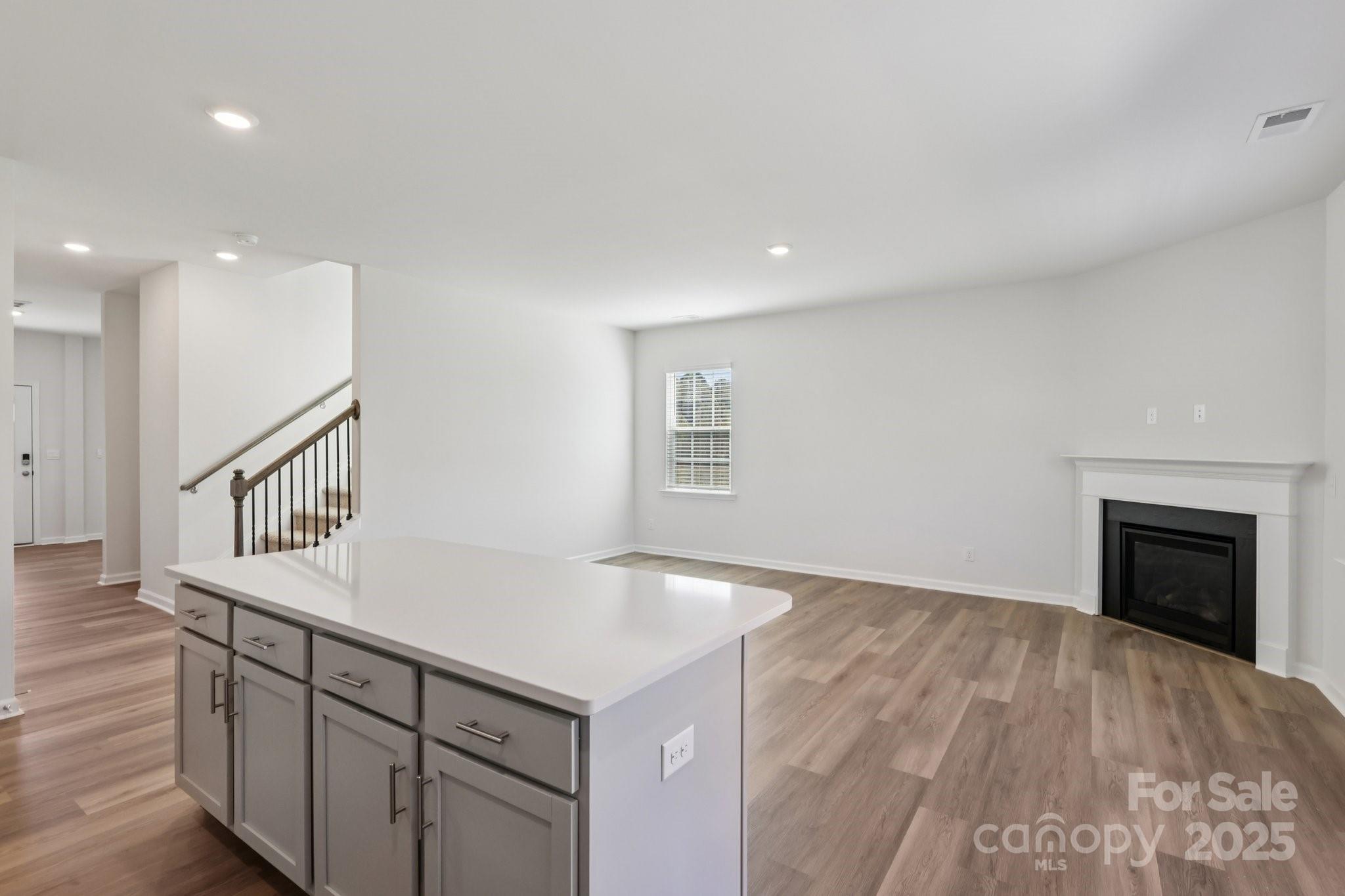 3919 Caroline Court Northwest Conover, NC 28613 - Photo 13 of 35 wooden floor in an empty room with a fireplace