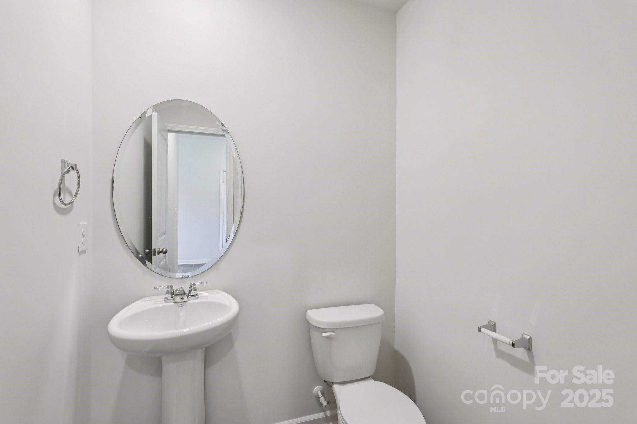 3919 Caroline Court Northwest Conover, NC 28613 - Photo 16 of 35 a bathroom with a toilet sink and mirror