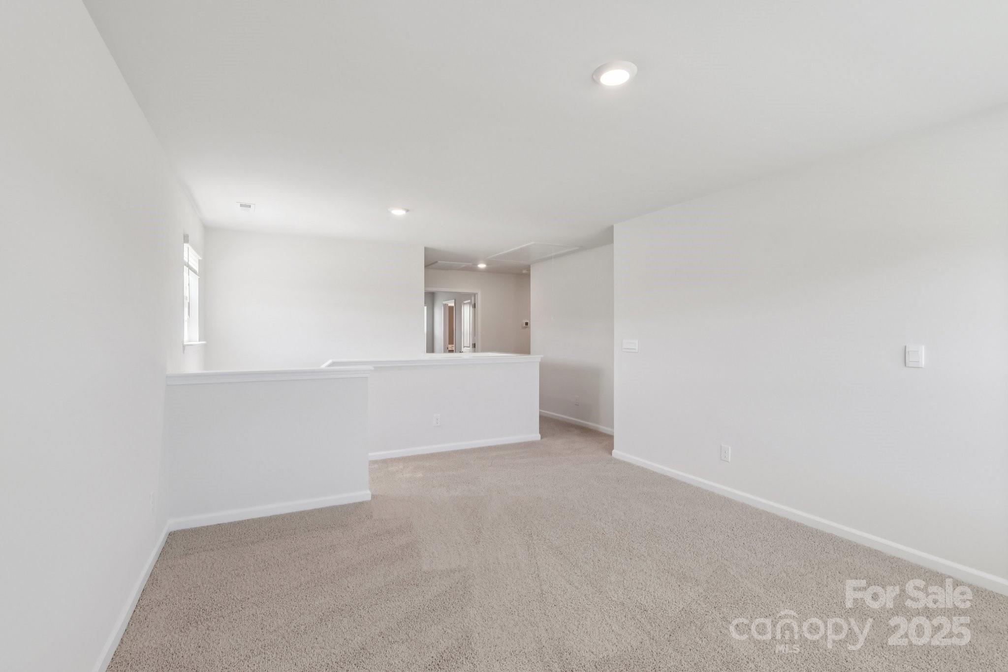 3919 Caroline Court Northwest Conover, NC 28613 - Photo 24 of 35 a view of an empty room with wooden floor and a window