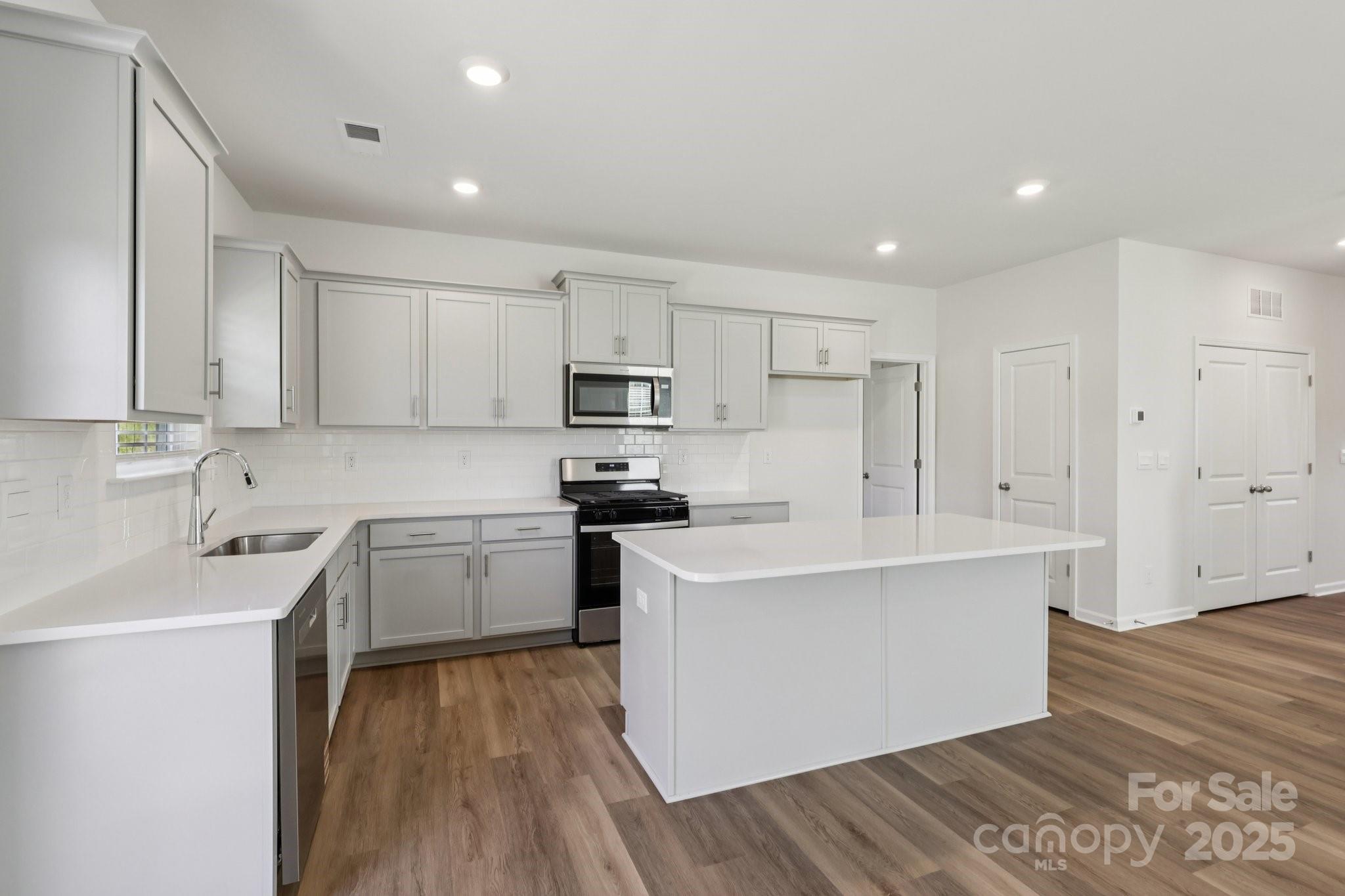 3919 Caroline Court Northwest Conover, NC 28613 - Photo 8 of 35 a kitchen with stainless steel appliances a sink stove and refrigerator