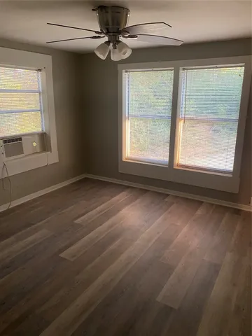 a view of a room with wooden floor