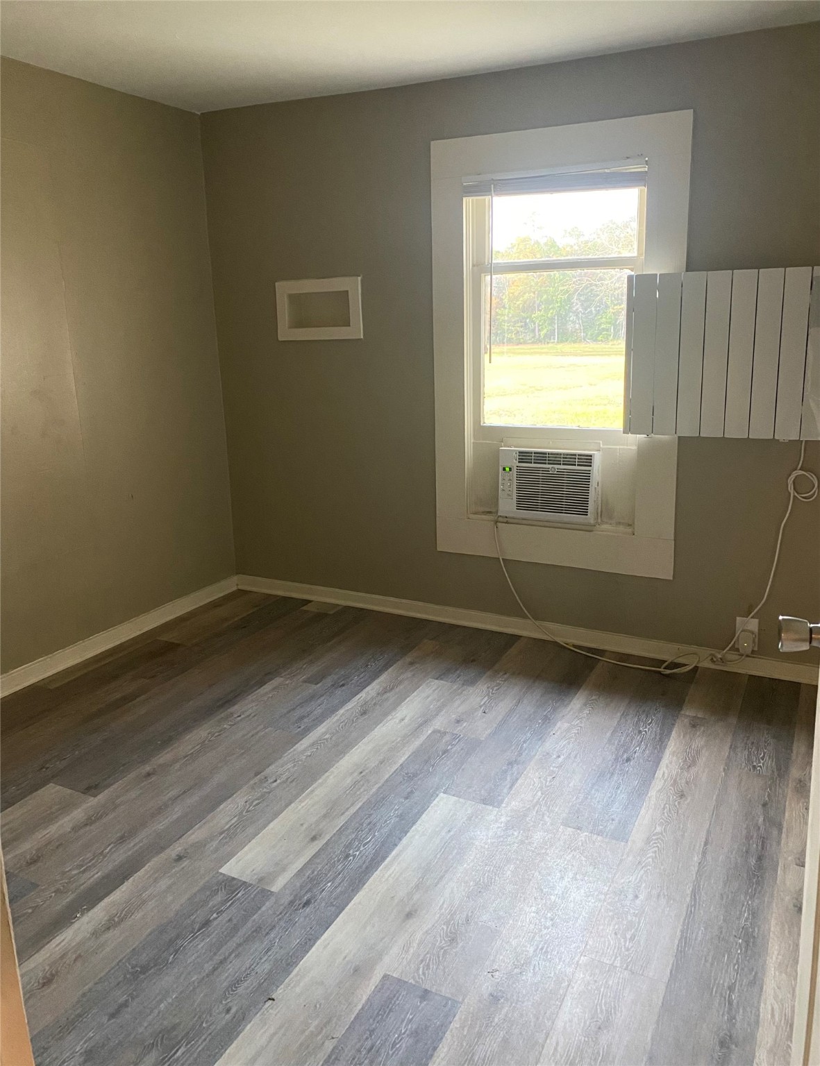 983 County Road, Unit 4350 Woodville, TX 75979 - Photo 16 of 18 a view of a room with wooden floor and a window