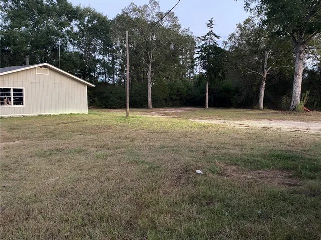 a backyard of a house with large trees