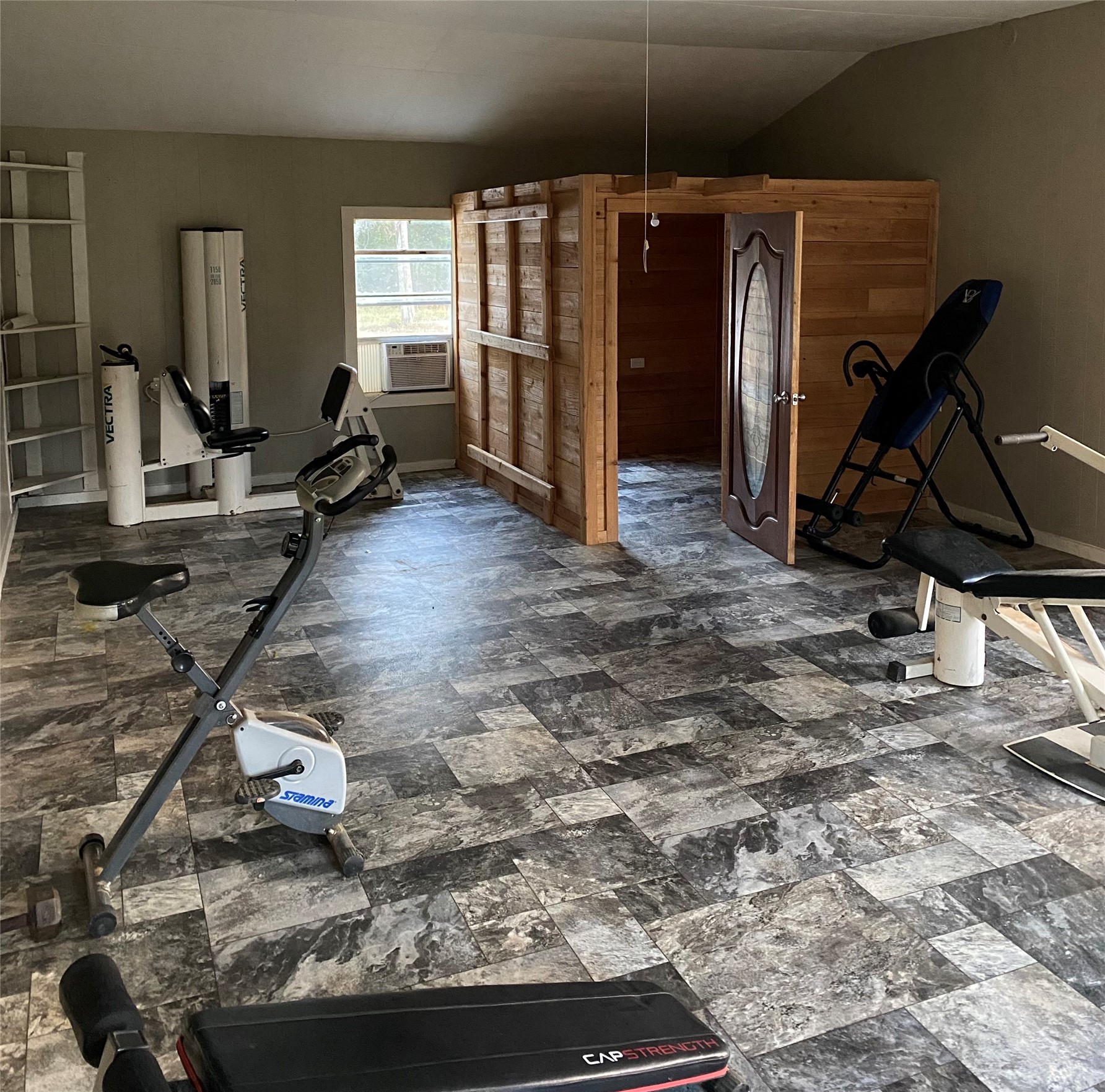 983 County Road, Unit 4350 Woodville, TX 75979 - Photo 8 of 18 a room with gym equipment and windows