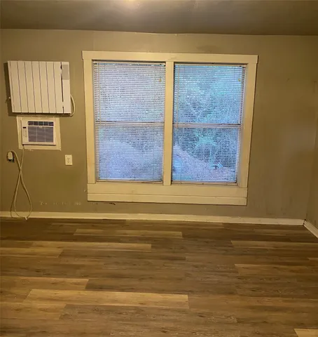 a view of a house with a yard and large tree