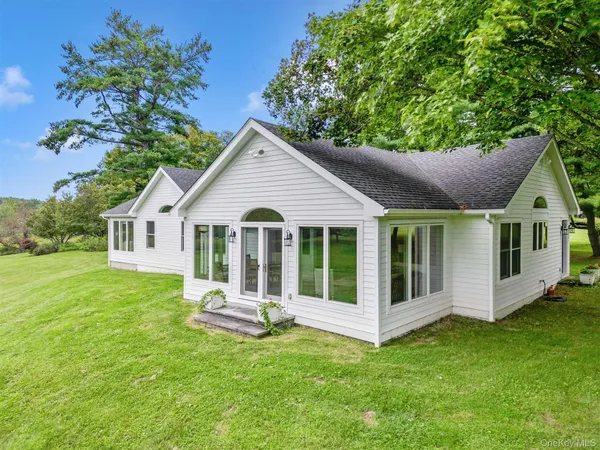 a front view of house with a garden