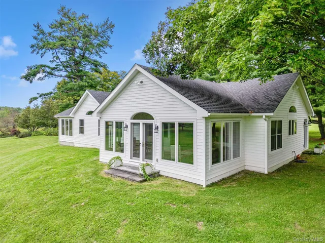 a front view of house with a garden
