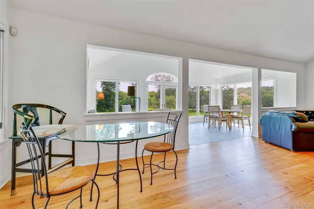 a view of a dining room with furniture window and wooden floor