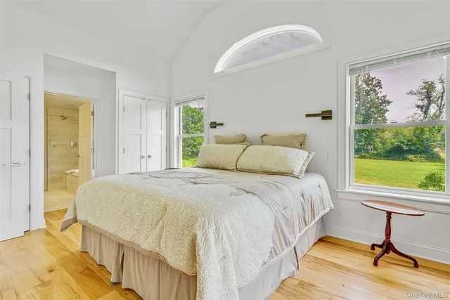 a bedroom with a bed and a large window