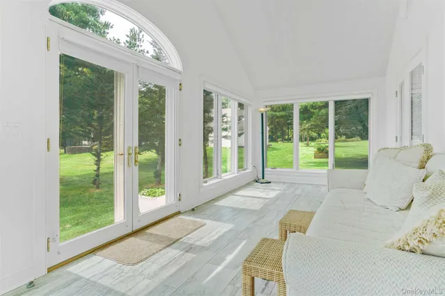 a spacious bedroom with a large bed and a large window