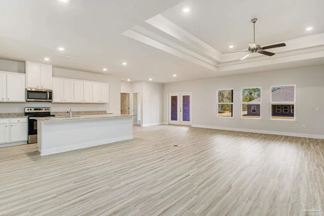 a view of kitchen with granite countertop cabinets and wooden floor