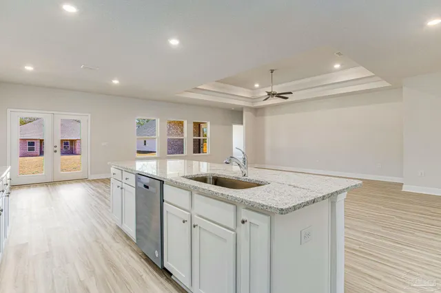 a kitchen with a sink appliances and cabinets