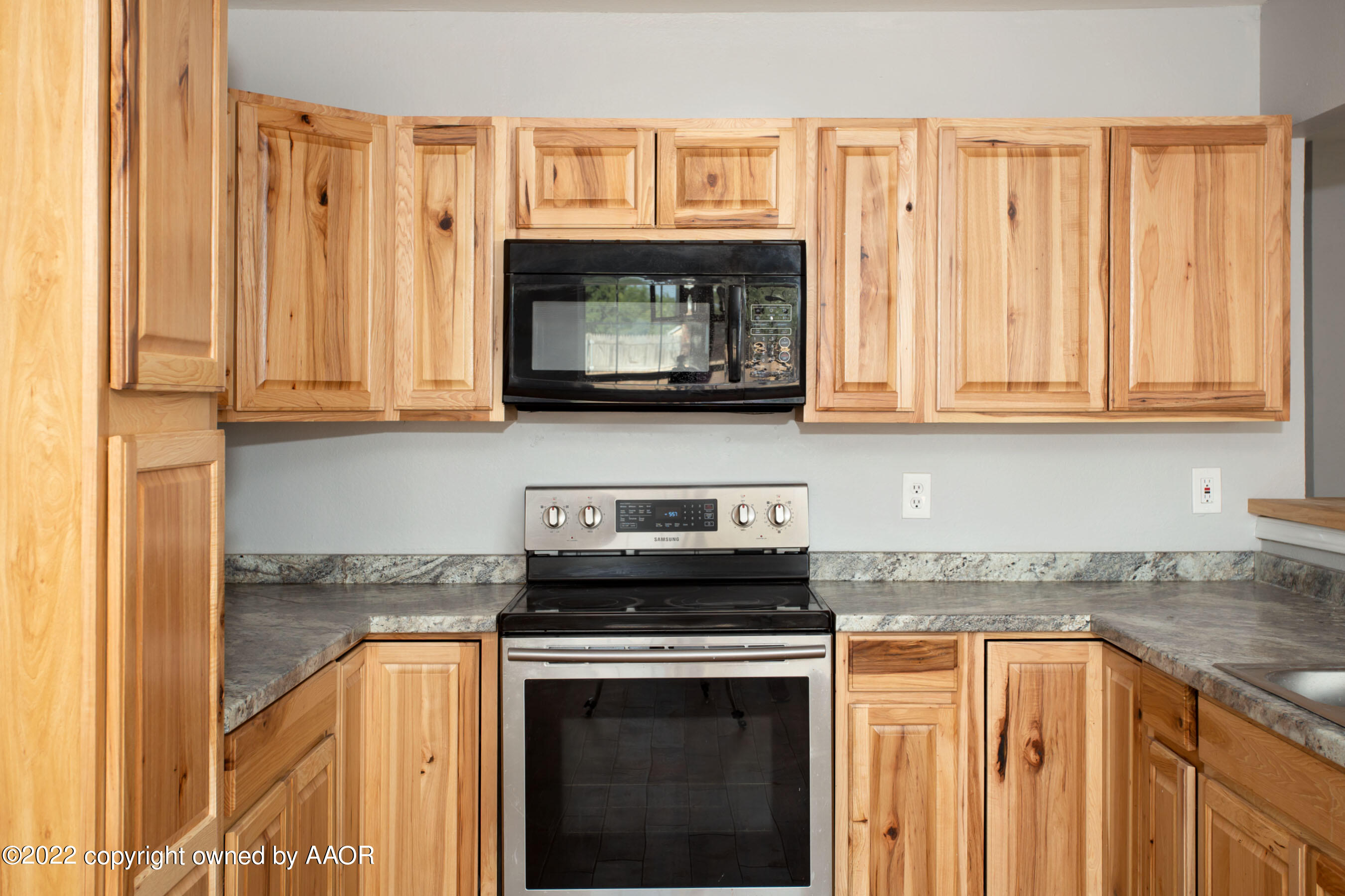 3808 Ross Street Amarillo, TX 79118 - Photo 11 of 22 a kitchen with stainless steel appliances granite countertop a stove a sink and a microwave