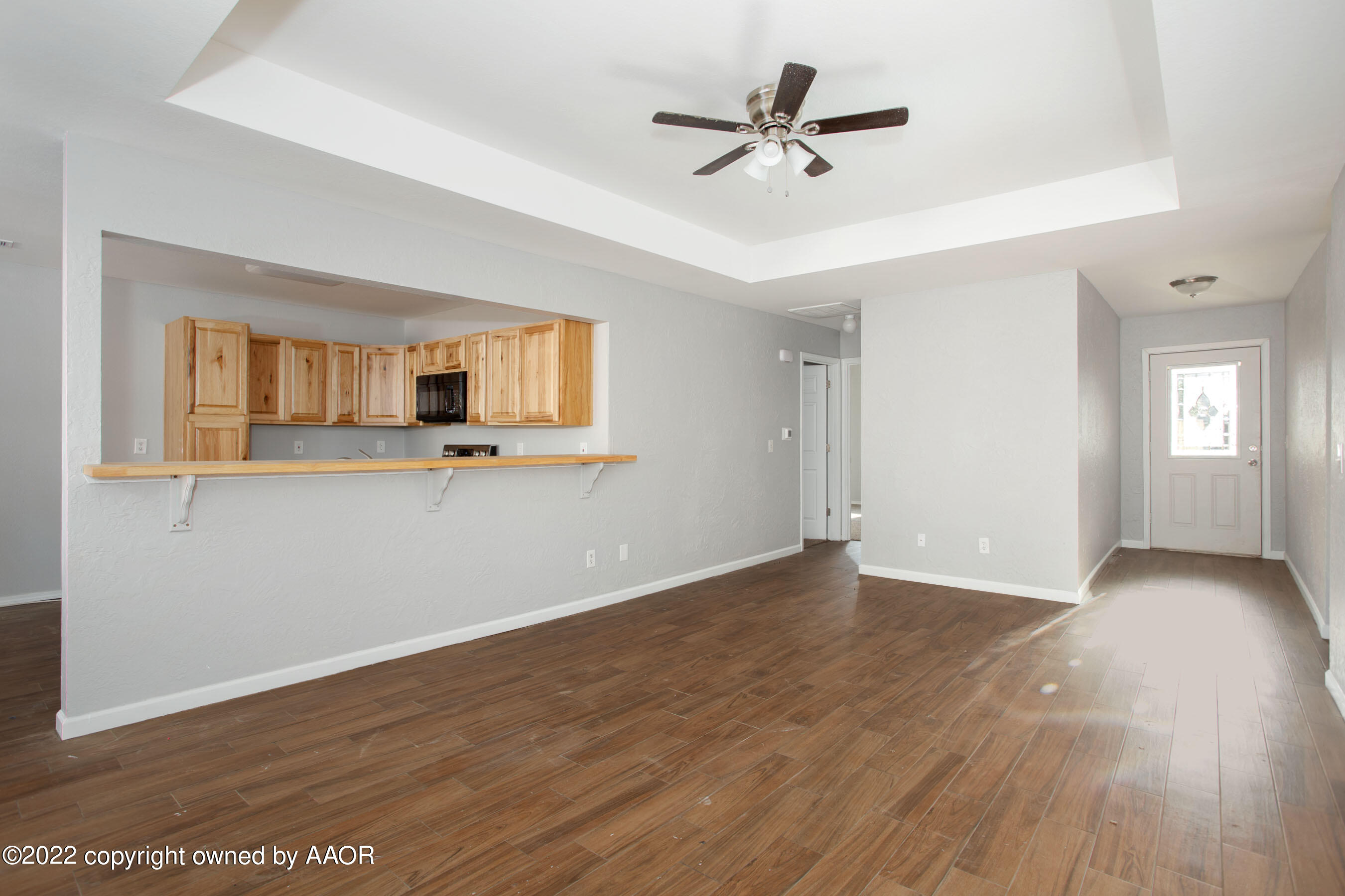 3808 Ross Street Amarillo, TX 79118 - Photo 2 of 22 a view of a room with window ceiling fan and wooden floor