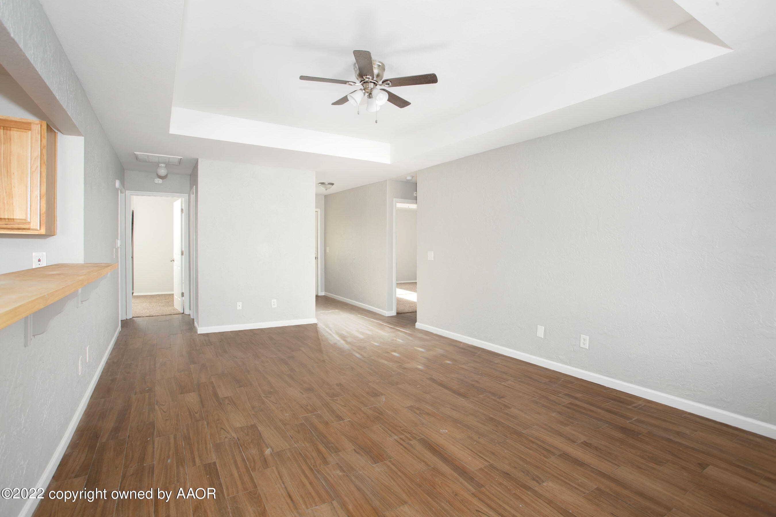 3808 Ross Street Amarillo, TX 79118 - Photo 8 of 22 a view of a livingroom with a ceiling fan & hardwood floor