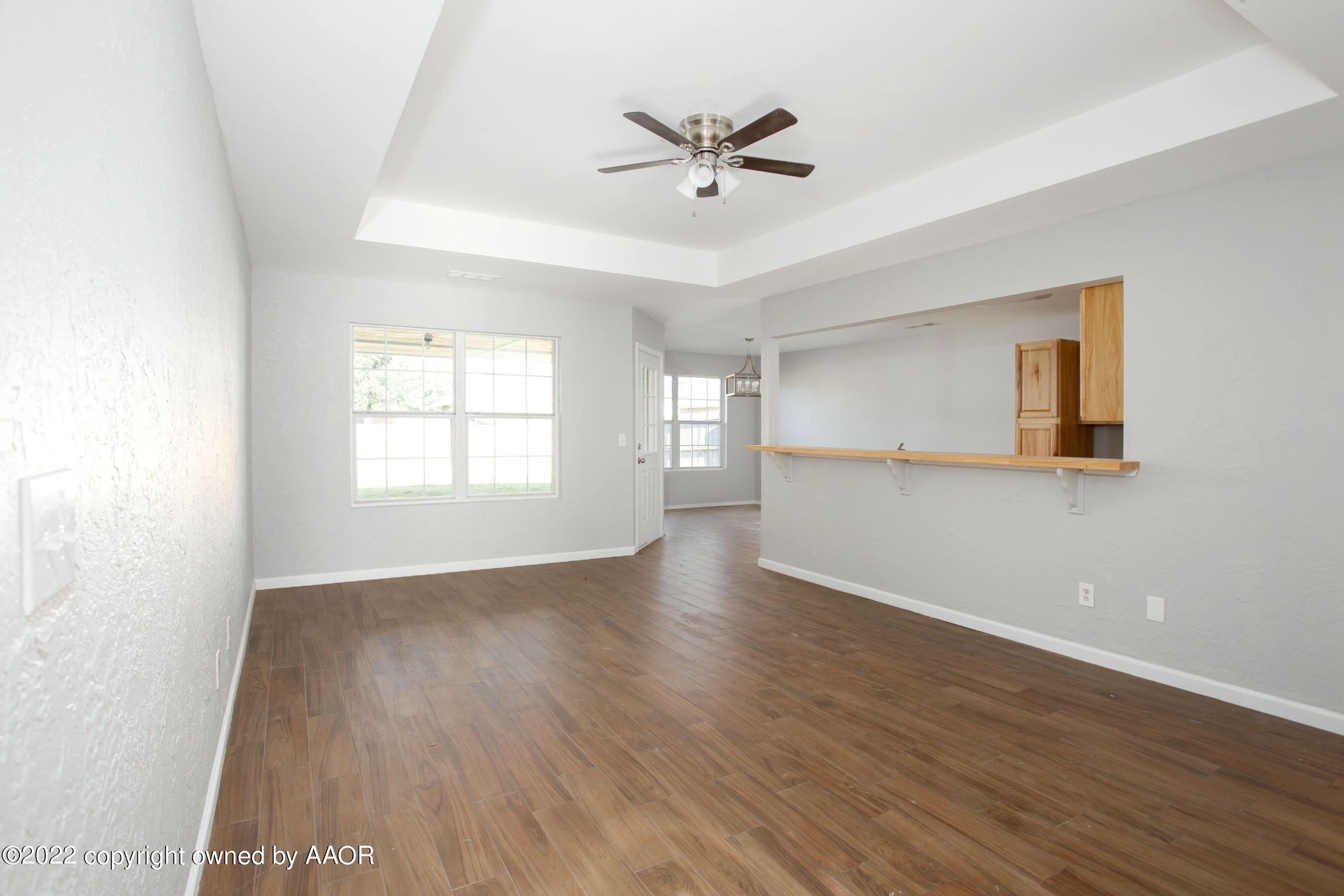 3808 Ross Street Amarillo, TX 79118 - Photo 9 of 22 a view of an empty room with a window and wooden floor