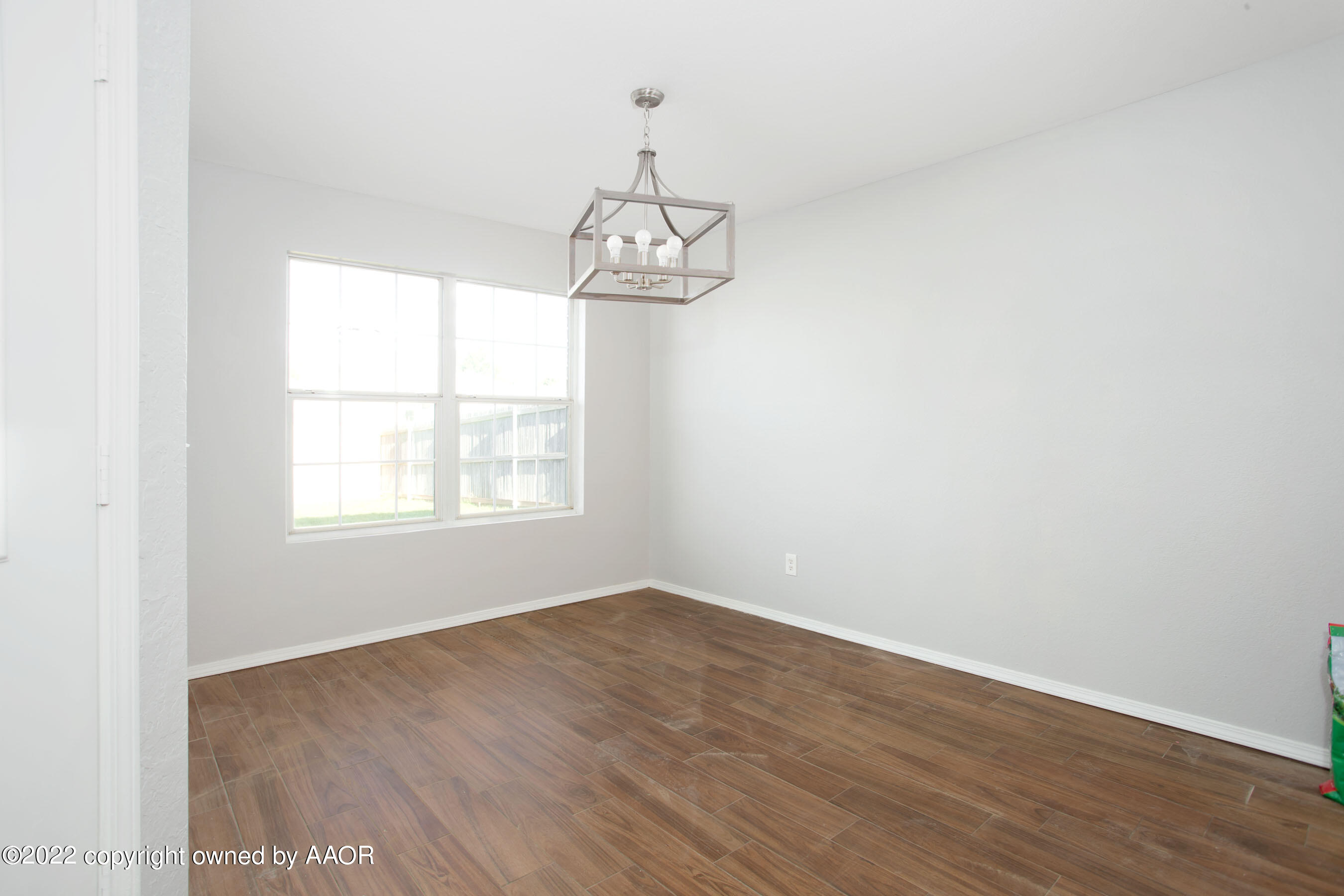 3808 Ross Street Amarillo, TX 79118 - Photo 10 of 22 an empty room with wooden floor fan and window
