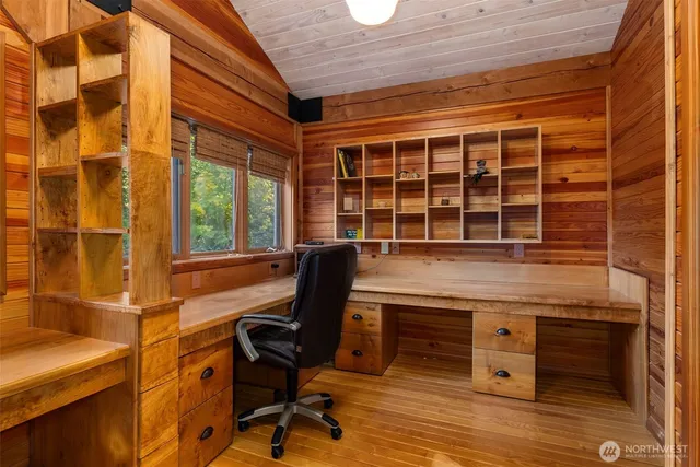a view of a workspace with furniture and a window