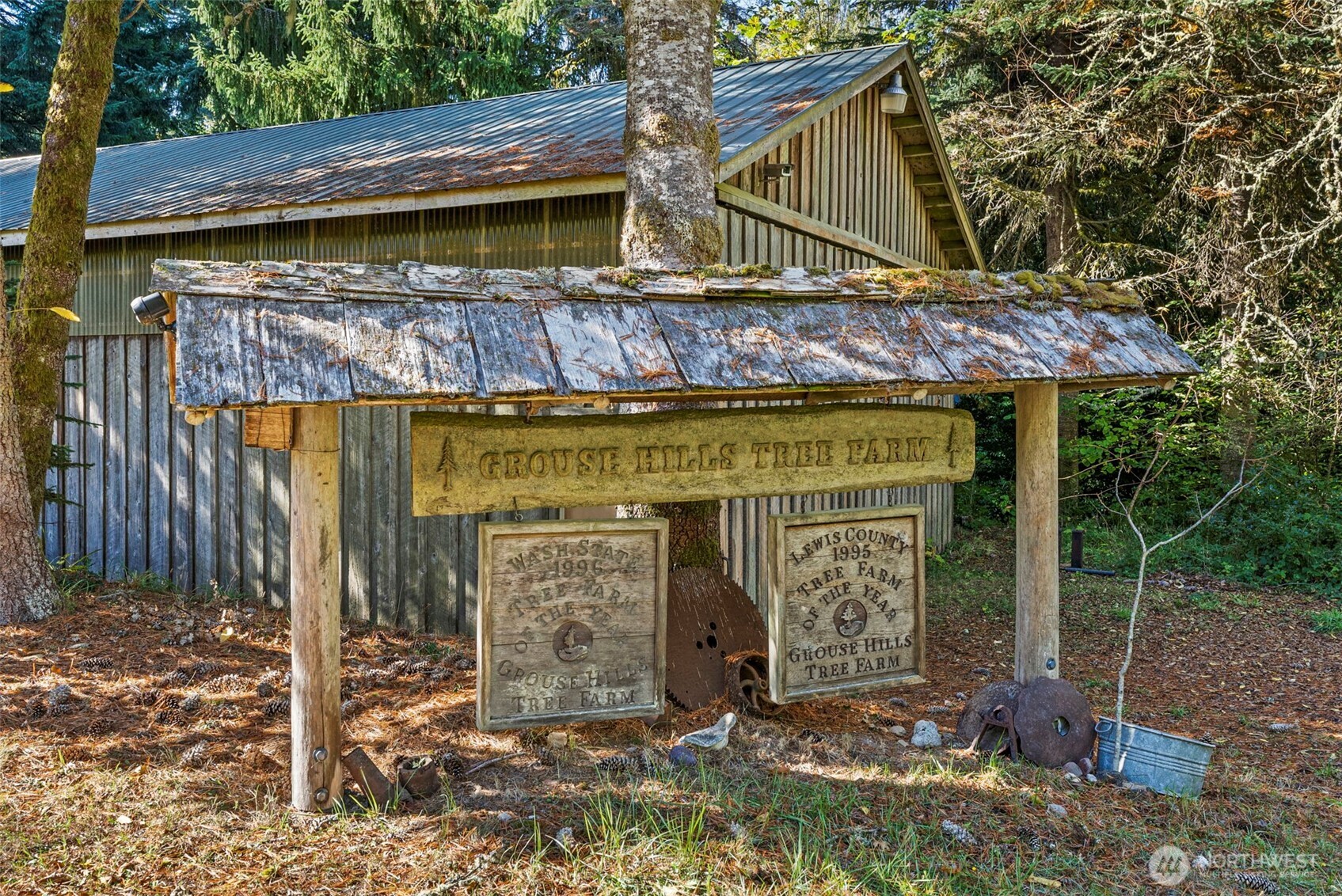 299 Conrad Road Winlock, WA 98596 - Photo 35 of 40 a view of a wooden house with large trees and wooden fence