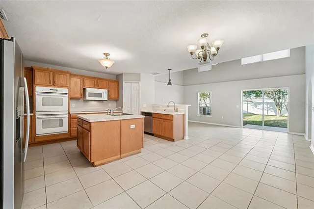 a kitchen with stainless steel appliances a sink and cabinets